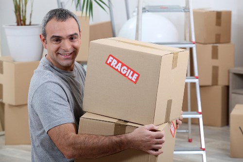Moving truck and packed boxes representing Movers Brixton services