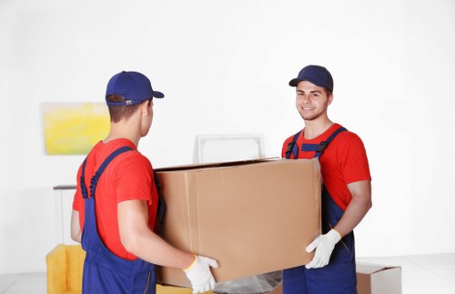 Furniture being carried through a narrow Brixton staircase during a move