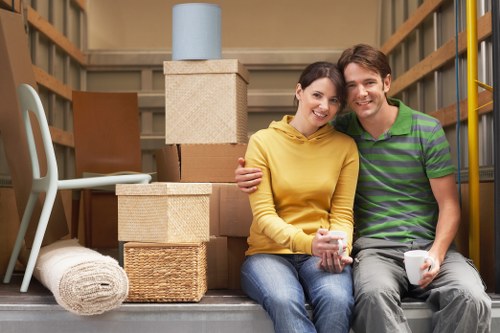 Local movers handling desks and boxes in a Brixton office relocation